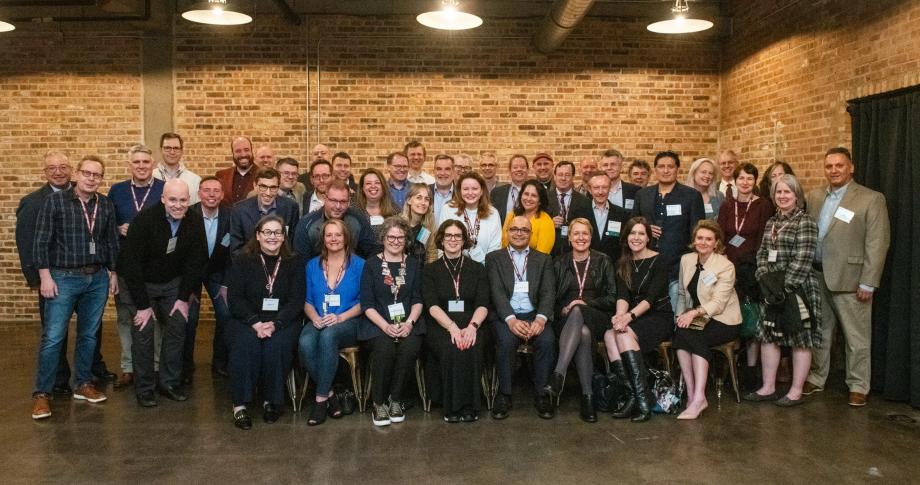 Members of the Class of 1999 gather for a special 25th milestone reunion celebration. A large group of people standing side by side and posing for a photo.