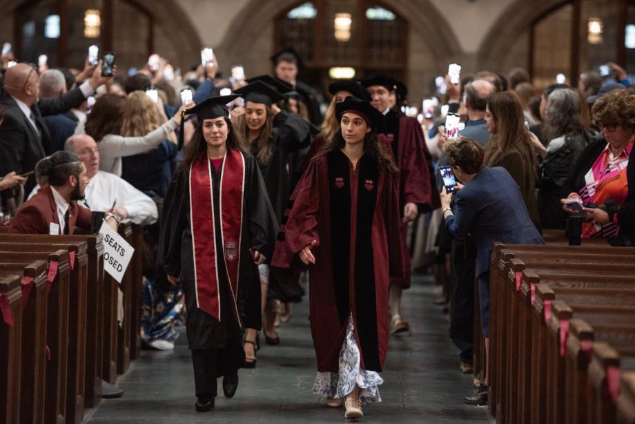 Two rows of students filed down the aisle of the chapel.