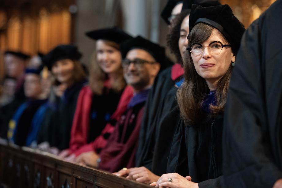 Bridget Fahey and other professors peer out at the students.