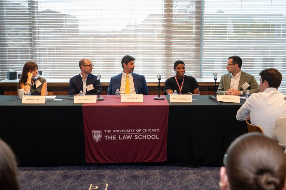 The Business panel included Selina MacLaren, ’14; Jud Finnegan, ’15; Jack Grein, ’15; Victoria Smallwood, ’16; and moderator, Will Shirey, ’21. Five panelists sit a table draped with a University of Chicago Law School tablecloth. One panelist, in a black sweater speaks into the tabletop microphone while the other panelists look on.