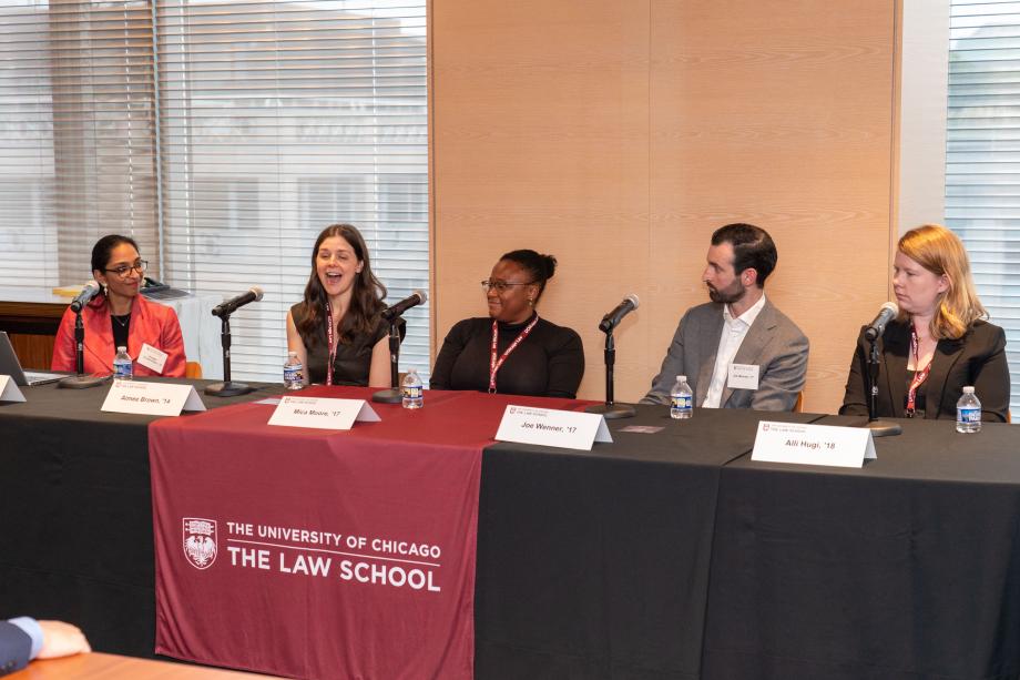 Sessions featured panels of Rubenstein Scholars discussing their career trajectories and current issues facing the legal profession. The Public Service panel included moderator Anagha Sundararajan, ’18; Aimee Brown, ’14; Mica Moore, ’17; Joe Wenner, ’17; and Alli Hugi, ’18. Five panelists sit a table draped with a University of Chicago Law School tablecloth. One panelist, in a black blouse speaks into the tabletop microphone while the other panelists look on.