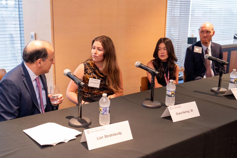 The plenary panel in the afternoon featured perspectives from current Rubenstein Scholars students Grace Hering, ’26; Jenna Liu, ’25; and Ian Peacock, ’25. Lior Strahilevitz, the Sidley Austin Professor of Law, moderated the panel. Four panelists sit a table draped with a University of Chicago Law School tablecloth. One panelist, wearing an orange, gold, and black blouse looks at the panelist to their left while preparing to speak.