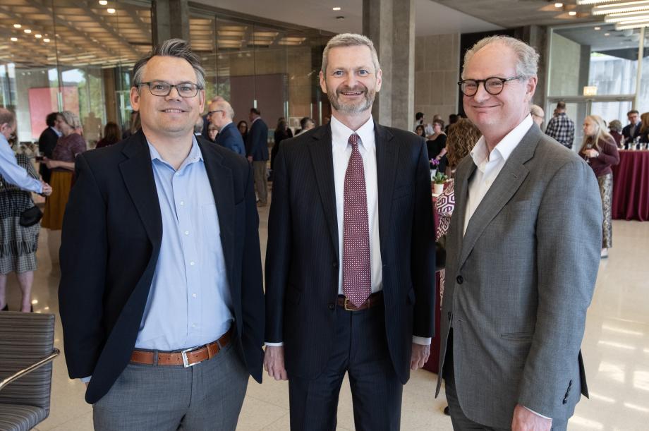 Adam Chilton, Thomas J. Miles, and President Paul Alivisatos stand side by side and look directly at the camera to pose for the photo.
