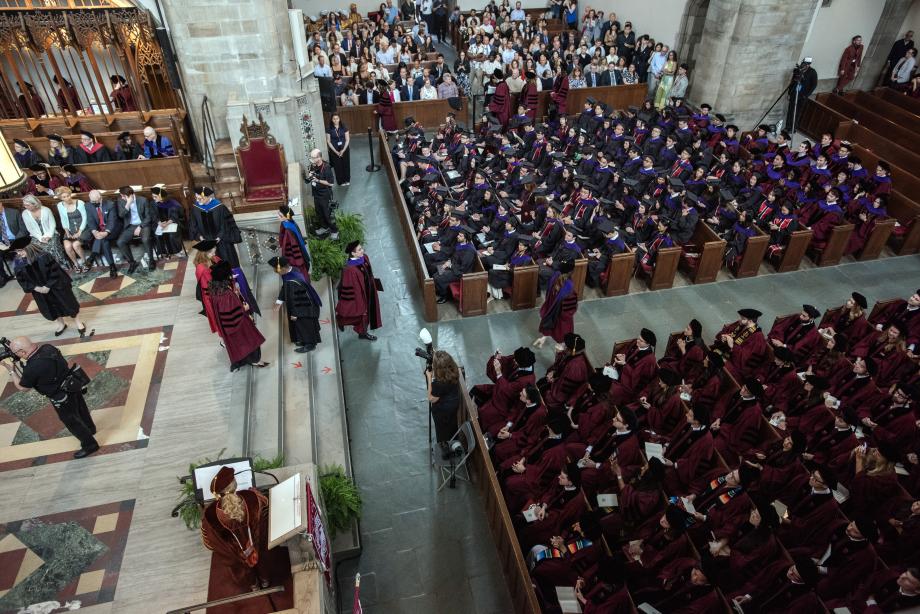 A total of 215 JD students, 82 LLM students, and 3 JSD students were awarded degrees at the event. An aerial wide-shot view of the inside of the chapel that is filled with graduating students and families sitting in the pews.