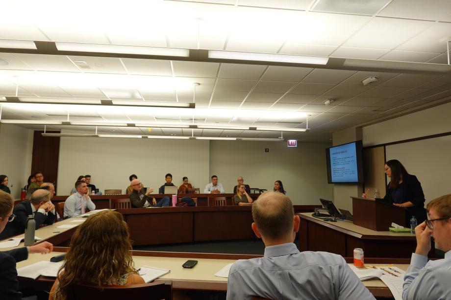 People listen to a speaker in a classroom