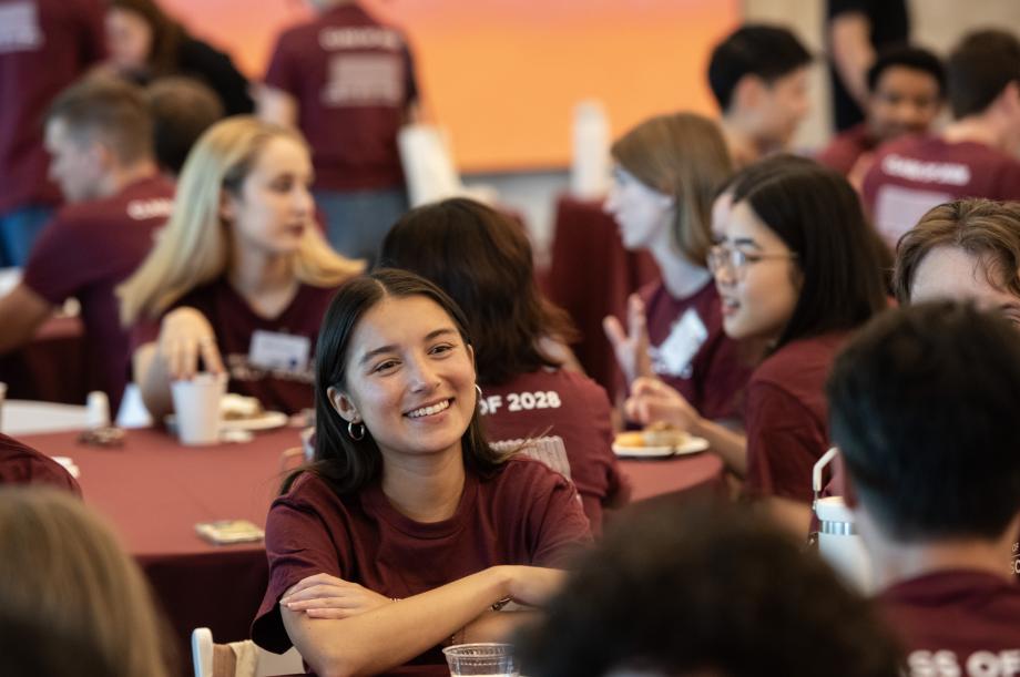 Students sitting at round tables.
