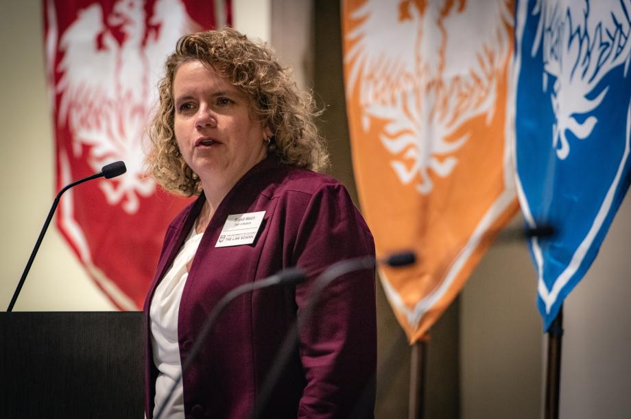 A woman at a lectern speaking.