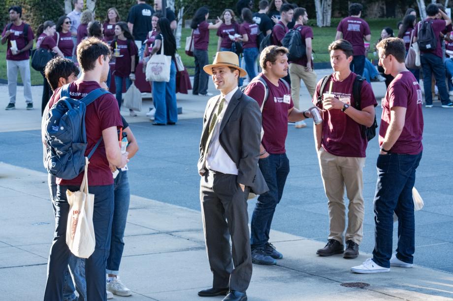 Students standing outside speaking.
