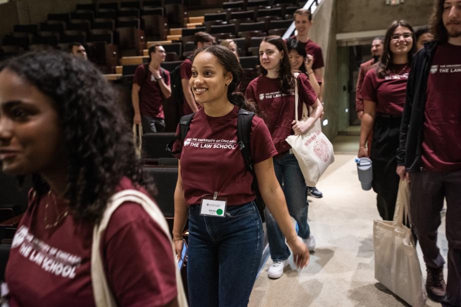 Students filing into an auditorium.