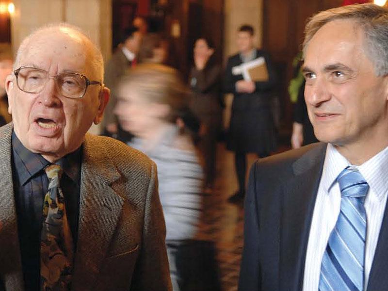 David Logan, ’41, (left) talks with President Robert Zimmer (right) after Logan’s historic $35 million gift.