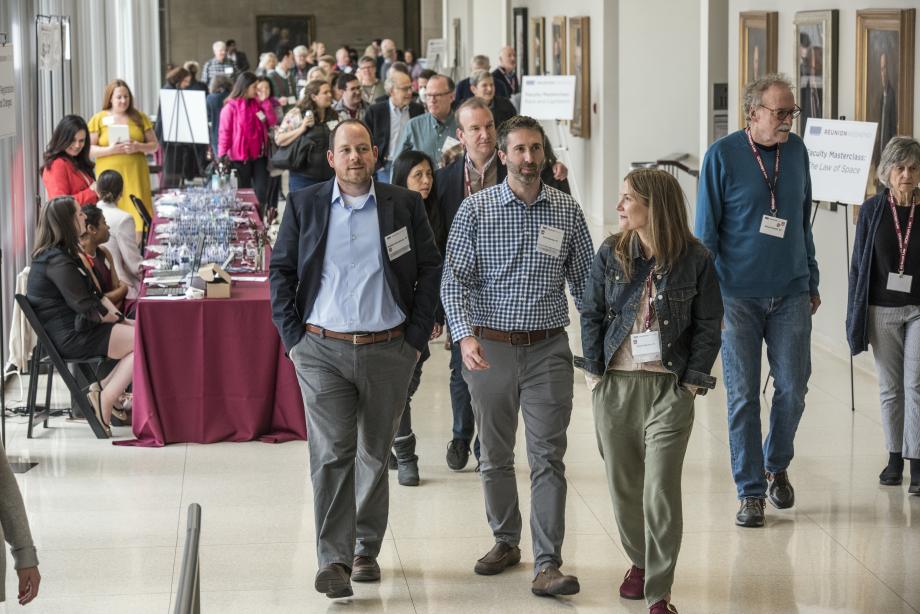 The hallway streams with people moving from one event to the next