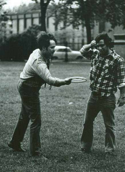 Dick Badger shows Harvey Levin, ’75, how to throw a frisbee.