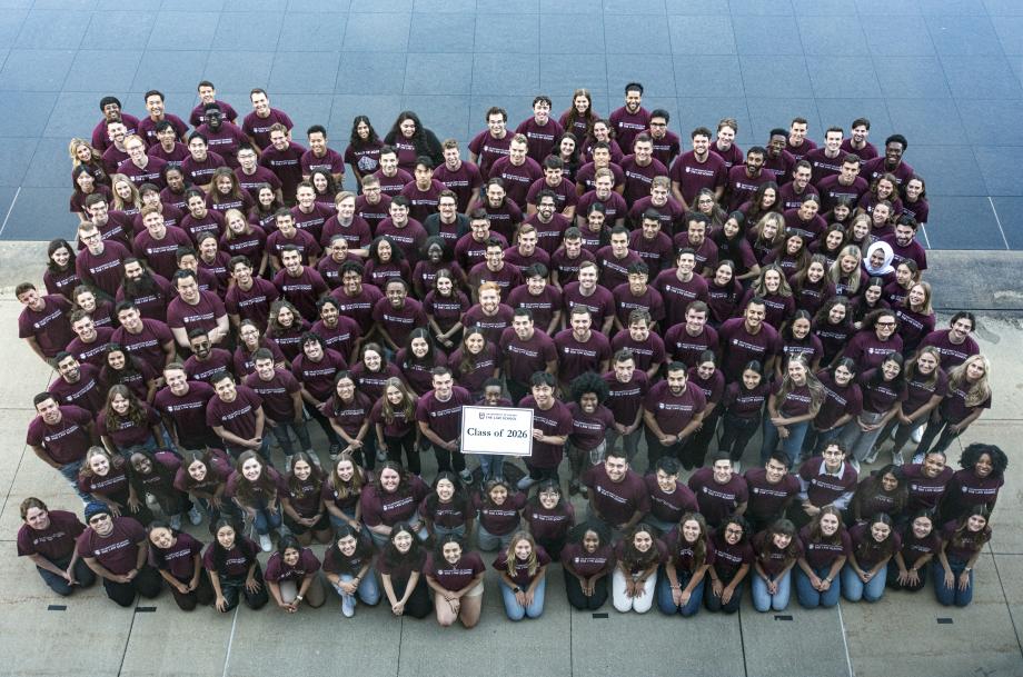 Almost 200 members of the class of 2026 pose for a class photo holding a sign "Class of 2026."