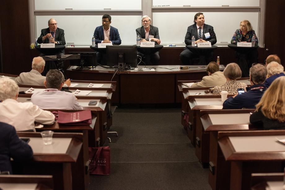 Law School faculty and two Class of 1969 alumni discuss “the Rule of Law” as an ideal and a constraint in American law and politics. Left to right: Mark Aaronson, ’69, Professor of Law Emeritus at the University of California College of Law, San Francisco; Aziz Huq, Frank and Bernice J. Greenberg Professor of Law; Geoffrey Stone, ’71, Edward H. Levi Distinguished Service Professor of Law; William Baude, Harry Kalven, Jr. Professor of Law; and the Hon. Judith Boggs, ’69, administrative appeals Judge at the U.S. Department of Labor. Four men and one woman sitting on a panel at the front of a classroom addressing a seated audience.