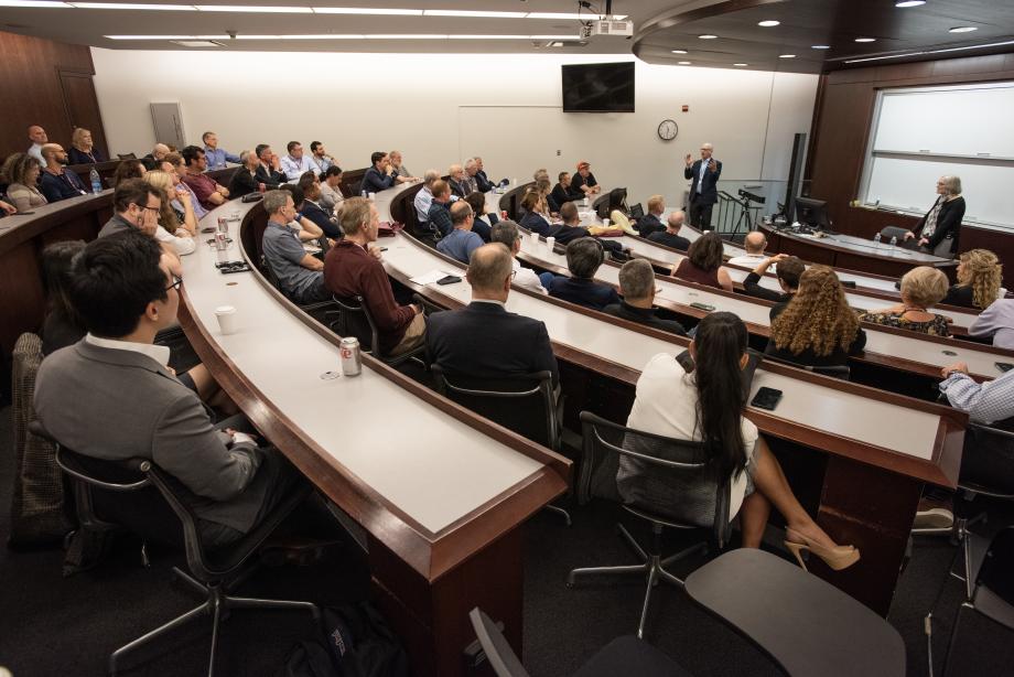 Saul Levmore, William B. Graham Distinguished Service Professor of Law, and Julie A. Roin, Seymour Logan Professor of Law, deliver a masterclass on “Musk and His Ideas.” A classroom filled with people listening to a man and a woman talking at the front of the room.