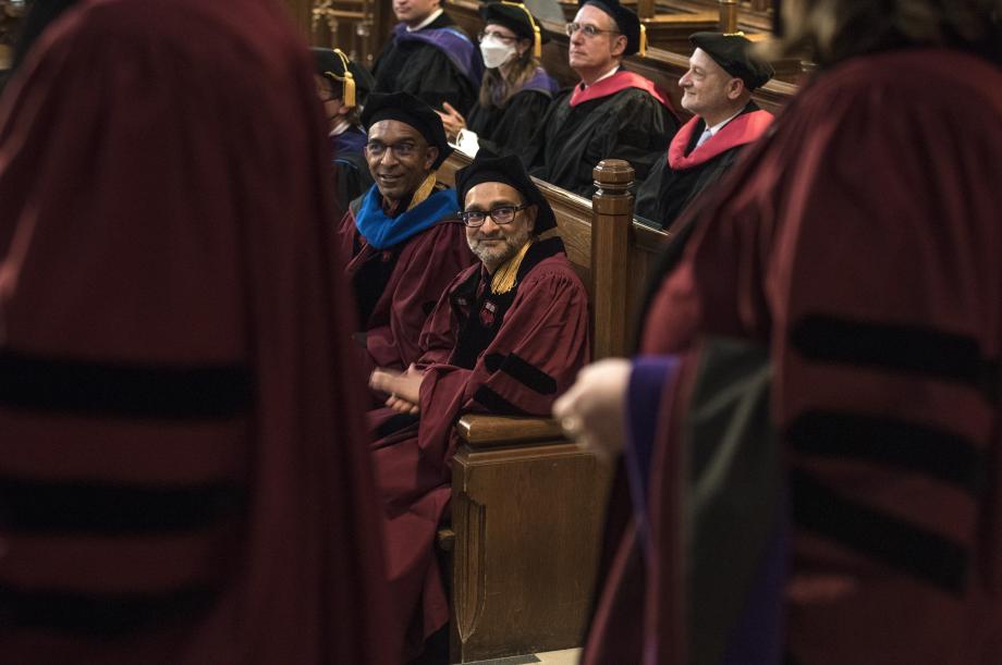 A view of several faculty members in their pews.