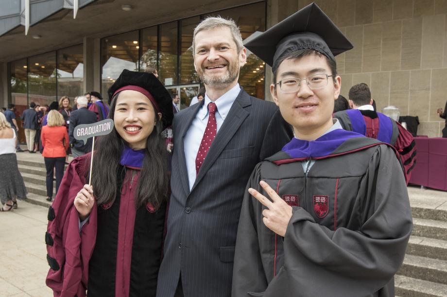 Two students pose with the dean.