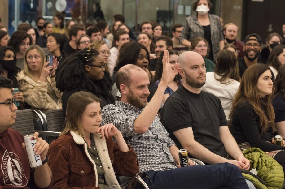 A student raises his hand to bid on an item.