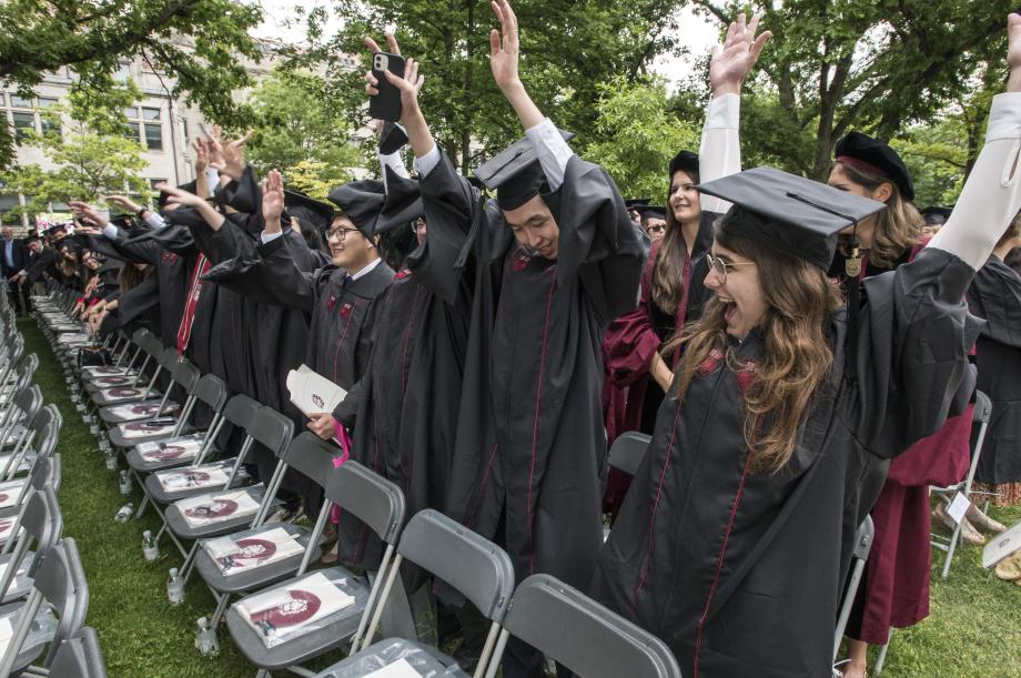 A group of LLM students cheering at the University convocation. 