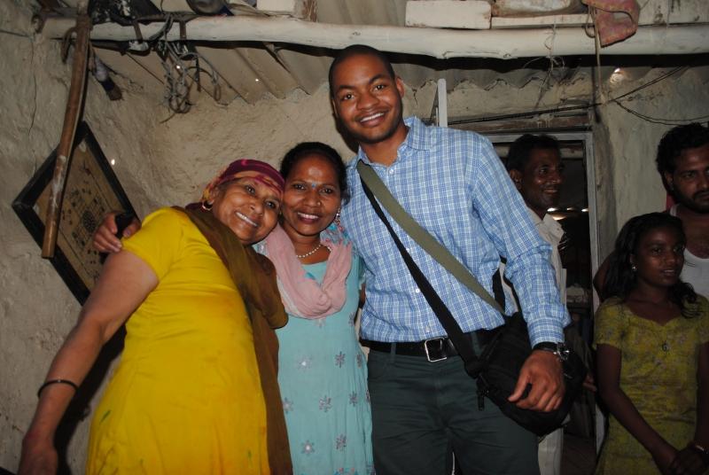 Clinic student Alex Kiles and community members inside a home in Baljeet Nagar.