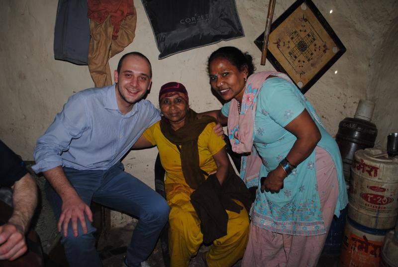 Clinic student Marco Segatti with local women inside a home. 