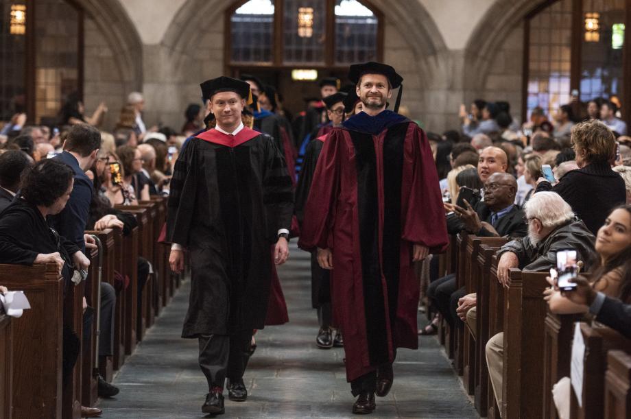 The faculty processed in first, led by Dean Thomas J. Miles (right) and Professor Jonathan Masur.