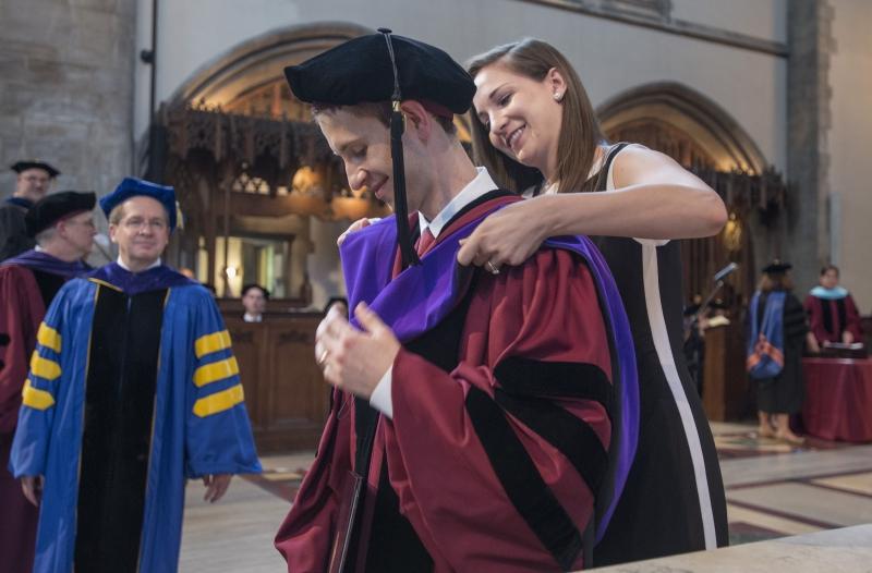 Adam J. Weiner, '16, received his hood from his wife, Heather Weiner, '14. Adam J. Weiner, '16, received his hood from his wife, Heather Weiner, '14.
