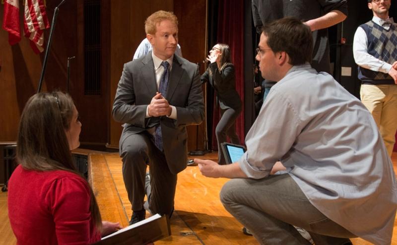 Professor Jonathan Masur, who did this year's traditional faculty cameo, receives some notes from the directing team at dress rehearsal. 