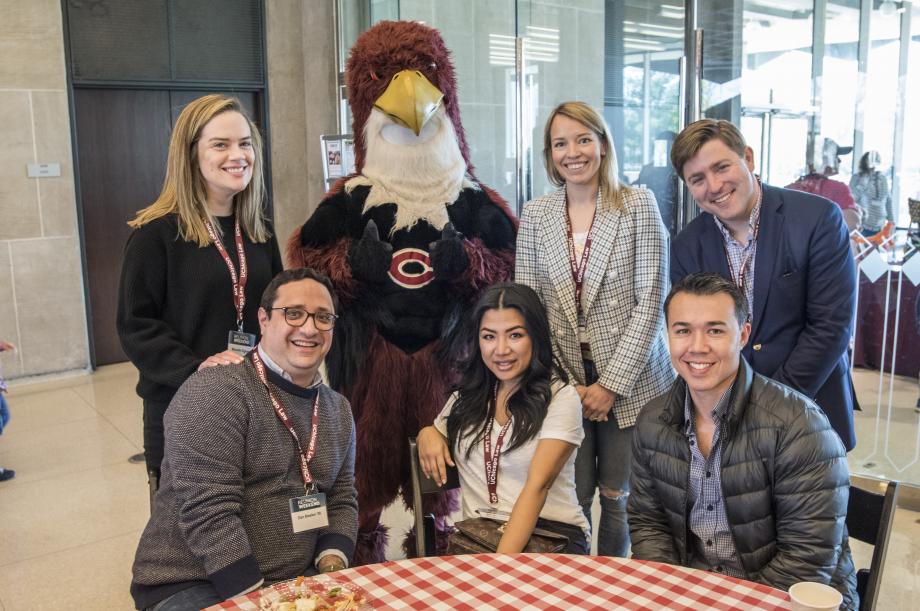 A group of alumni met mascot Phil the Phoenix in the Green Lounge.