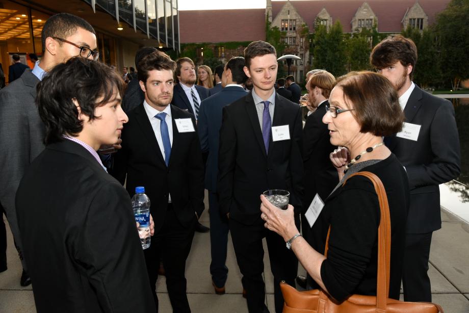 Here, several first-year students chat with Professor Julie Roin (right).