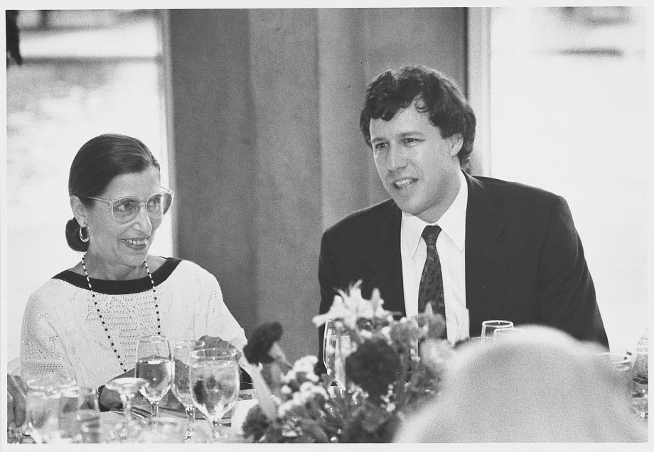 Geoffrey Stone with the late US Supreme Court Justice Ruth Bader Ginsburg at the D’Angelo Law Library Dedication in 1987. Stone, in a suit and tie, sits next to Bader Ginsburg, in a dress, who smiles at him.