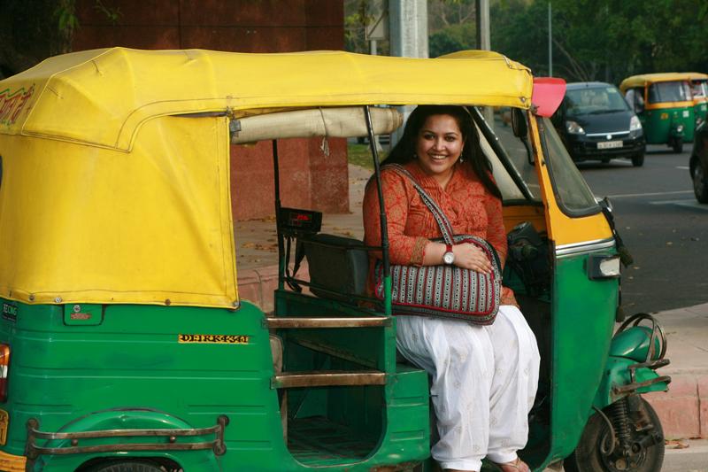 LLM student Subha Chauhan poses in an auto-rickshaw in New Delhi, India.