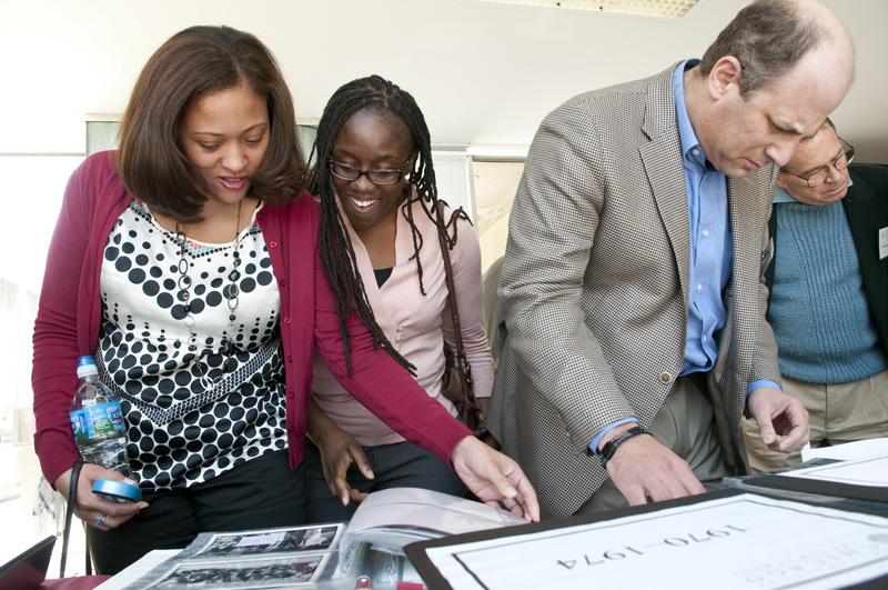 Alumni paged through photo albums looking for photos of classmates.