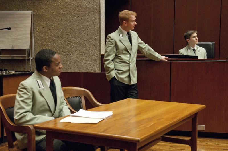 Professor Masur cross examines a witness as Paxton Williams, '13, and Chris Skene, '12, listen in.