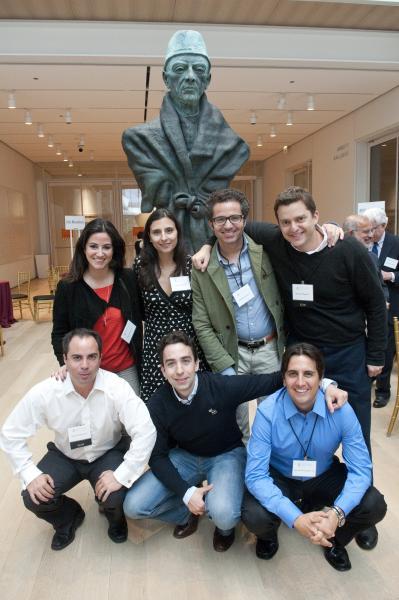 A group of LLMs pose for a photo at the All-Alumni Wine Mess at The Modern Wing of the Art Institute of Chicago.