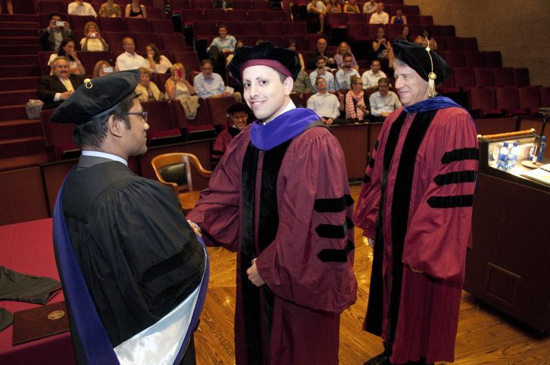 David Avraham was hooded by Professors Aziz Huq and Geoffrey Stone on June 8.