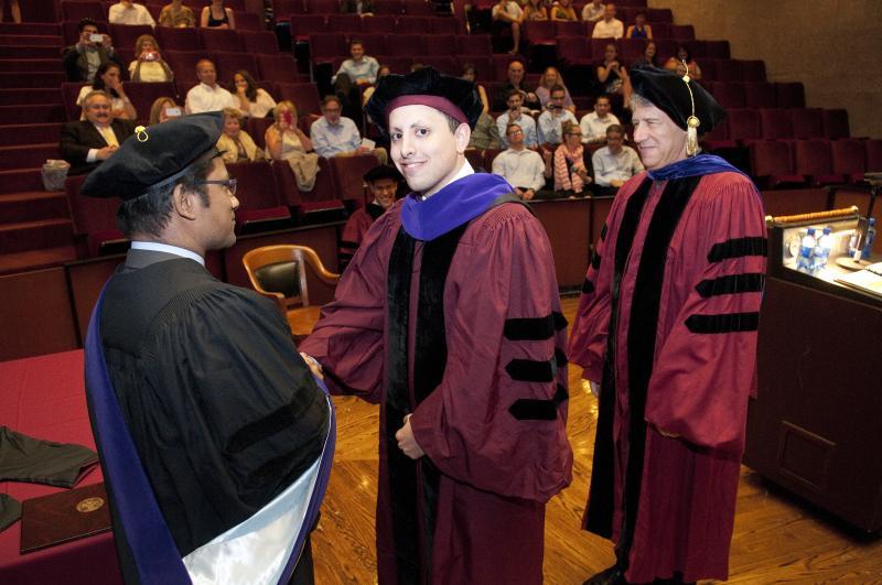 David Avraham was hooded by Professors Aziz Huq and Geoffrey Stone on June 8. David Avraham was hooded by Professors Aziz Huq and Geoffrey Stone on June 8.