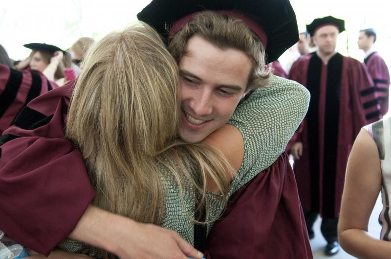 Proud parents embraced their children after graduation. 