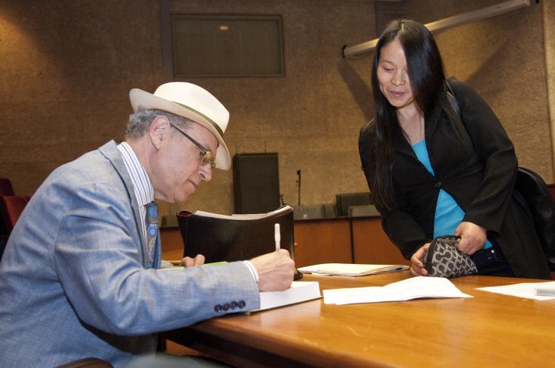 Lecturer in Law Richard Sandor signs his new book for a student. Lecturer in Law Richard Sandor signs his new book for a student.
