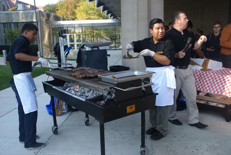 Students lined up at the big outdoor grill. Students lined up at the big outdoor grill.