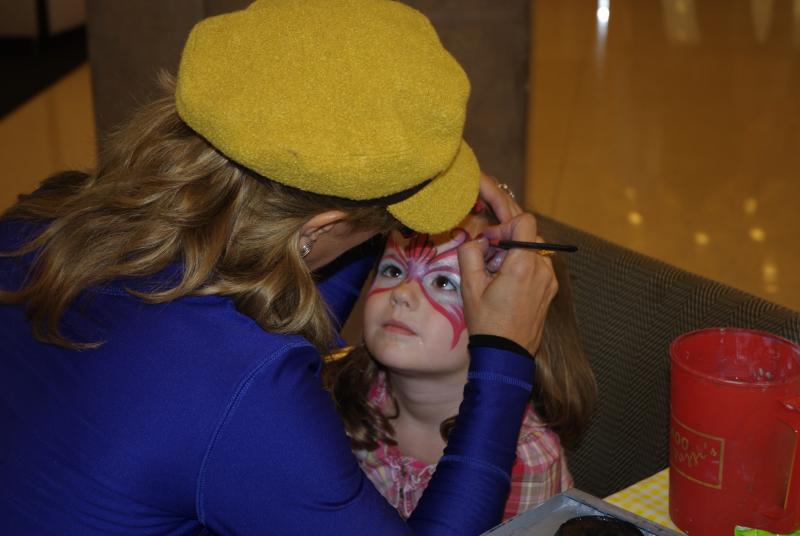 A face-painting artist created intricate designs on the children's faces. 