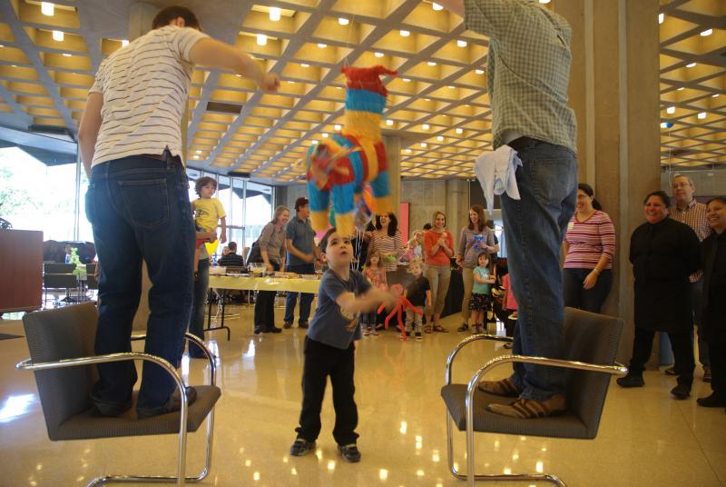 Two students held the pinata between them on a string while the kids took turns. Two students held the pinata between them on a string while the kids took turns.