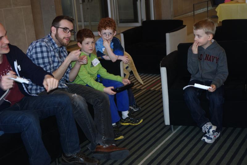 Niko Plassaras, '14, plays Wii with some young competitors. 