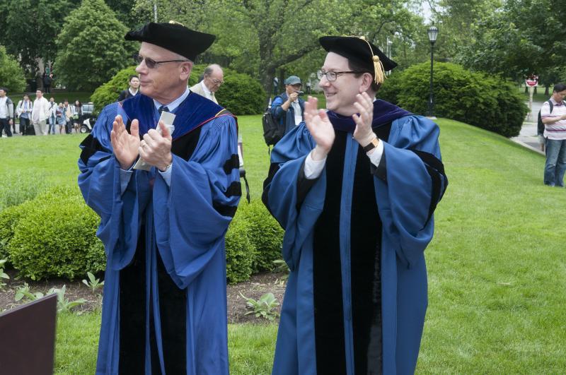 Professor Levmore and Dean Schill applaud the new graduates. 