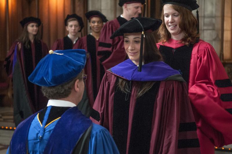 Rebecca Horwitz, '13, is hooded by Professors Baird and LaCroix. 