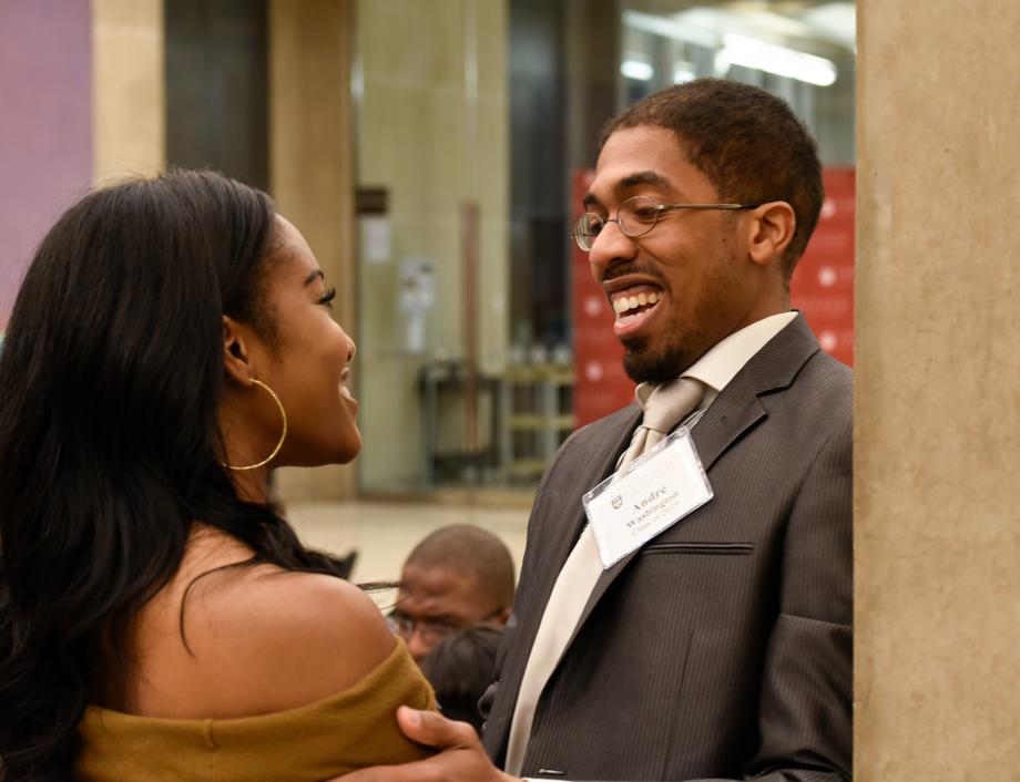 Andre Washington, '19, (right, talking to Whitney Nebolisa, an associate at Sidley Austin's Chicago office.
