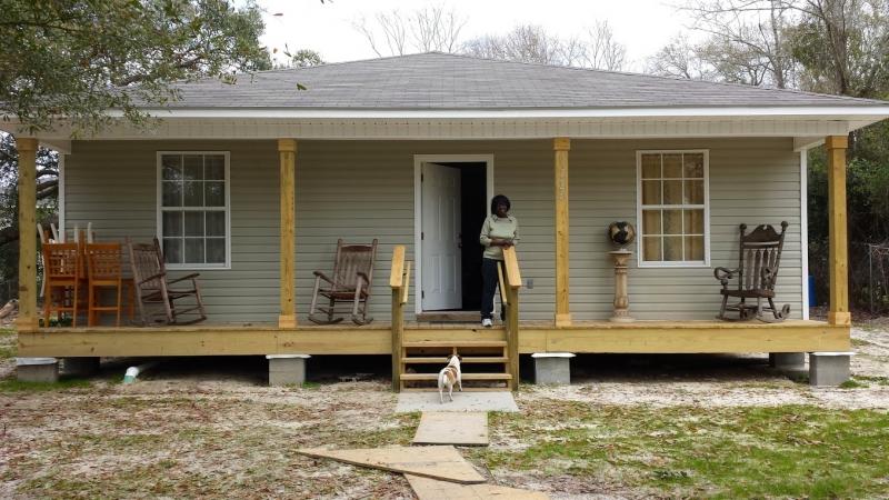 Students met with a woman helped by MCJ's Hurricane Katrina rebuilding project. 