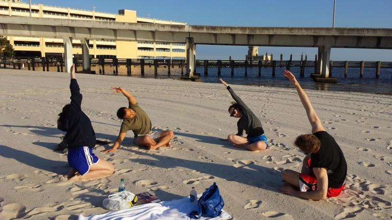 Students practiced yoga on the beach in Biloxi. 