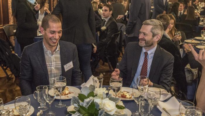 Doerfler and Miles chat at a table at the dinner