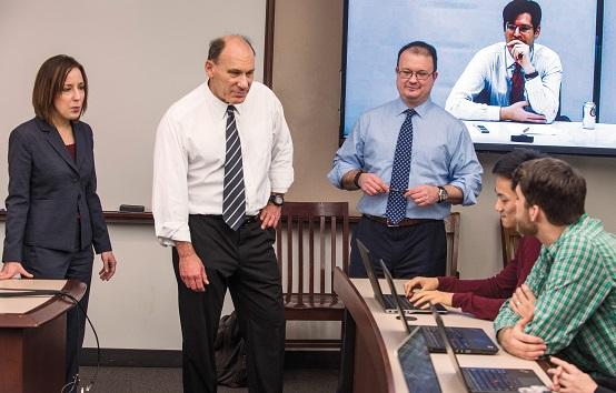 Professors Sarah Konsky and David Strauss, Lecturer Michael Scodro, and Jenner & Block partner Matthew Hellman talk to clinic students.